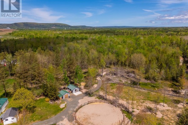 Wide view of property with riding arena, mobile home, and forested area. - 278 Fitch Road, Clarence East