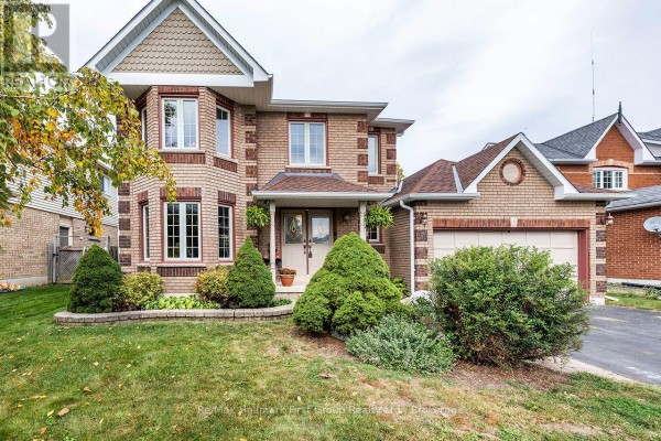 Front exterior of a brick house with a manicured lawn and bushes. - 278 St Joseph Road, Kawartha Lakes