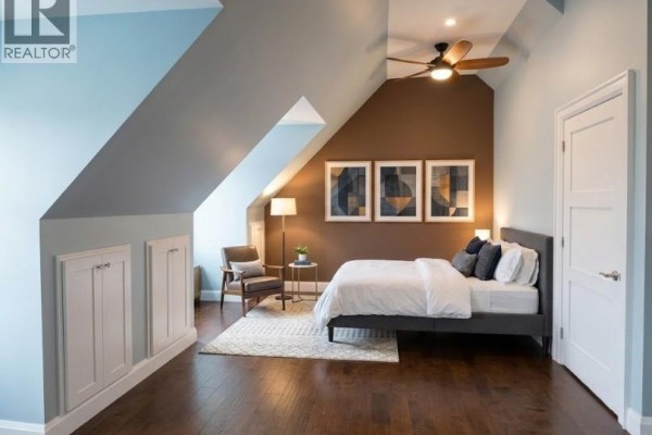 Living area with a fireplace, sofa, mounted television, and angled ceiling. - 2784 South Grimsby Rd 20 Unit# Upper, West Lincoln