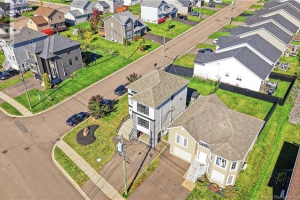 High aerial view of a modern house with a fenced backyard and surrounding suburban street. - 279 Freeman, Moncton