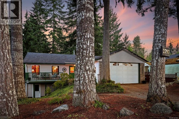 View of the residence through surrounding trees at dusk. - 2797 Keswick Ave, Cumberland