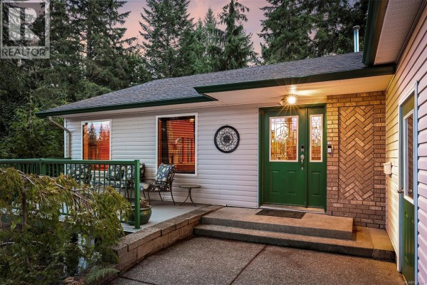 Close-up view of the front entrance with green double doors and a covered porch. - 2797 Keswick Ave, Cumberland