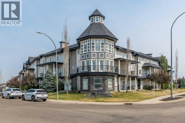 Exterior view of multi-unit townhouse complex with a central turret. - 28, 298 Somerset Way Se, Medicine Hat