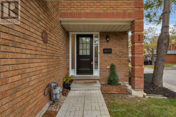 Close-up of the front door with sidelights, brick facade, and paved walkway. - 28 - 165 Kozlov Street, Barrie