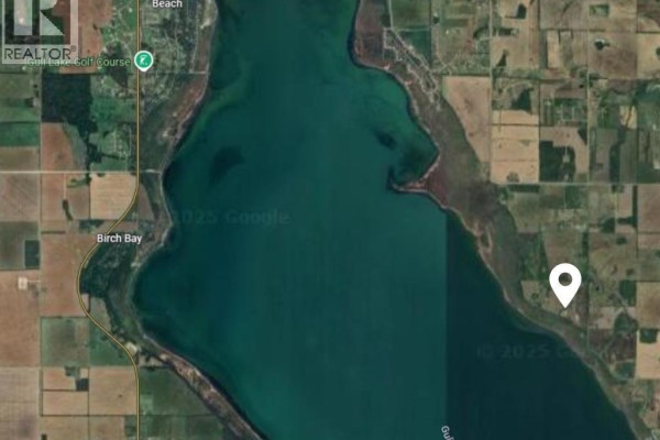 Aerial view of Gull Lake with shoreline, surrounding fields, and a white location pin. - 28-4 Range Road, Rural Lacombe County