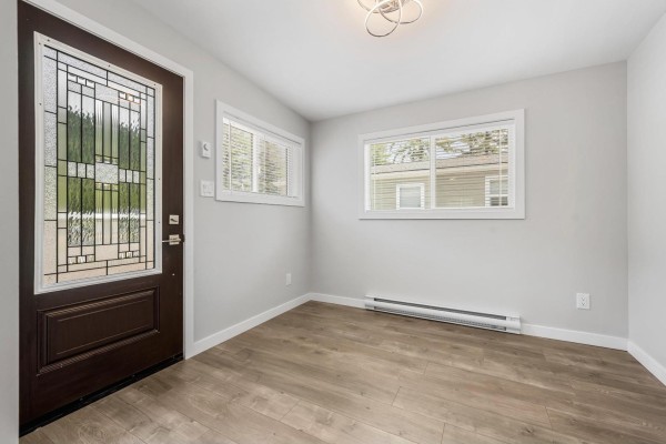 Interior entryway with a dark brown front door, two windows, and light grey walls. - 28 65367 Kawkawa Lake Road, Hope, Hope