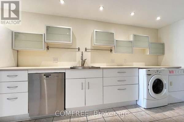 Laundry room with white cabinets, stainless steel dishwasher, washer, and dryer. - 28 Bluejay Drive, Barrie