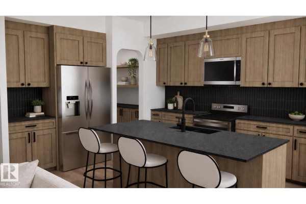 Kitchen with light wood cabinets, stainless steel refrigerator, island with dark countertop and bar stools. - 28 Brickyard Vw, Stony Plain