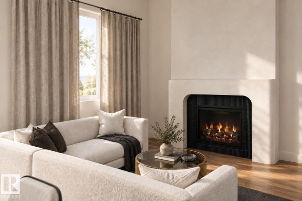 Living room with a cream sectional sofa, gas fireplace, and large window with linen curtains. - 28 Brickyard Vw, Stony Plain