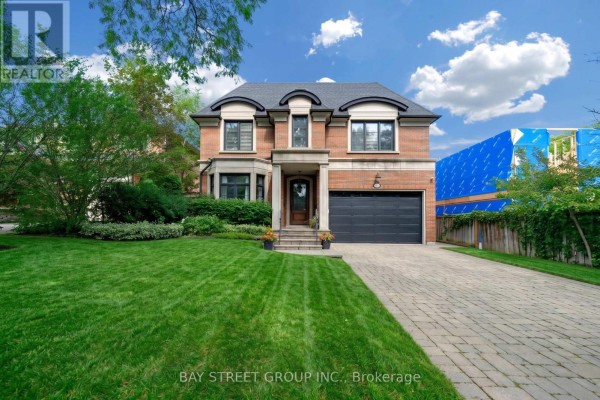 Foyer with marble tile floors, white wainscoting, and a crystal chandelier. - 28 Carnwath Crescent, Toronto