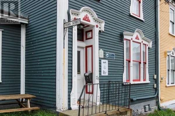 Close-up of the teal building entrance with a York Street sign and red accents. - 28 Cochrane Street, St  John S