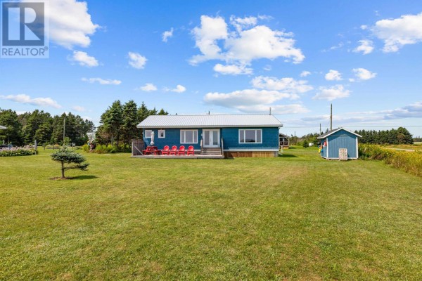 A small teal shed with a dark roof, decorated with colorful buoys and a wooden pallet. - 28 Gordons Way, Augustine Cove