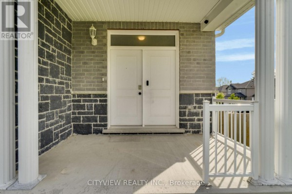 Close-up of the duplex front entrance with double white doors and stone facade. - 28 Hartfield Street, Ingersoll