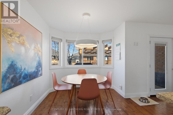 Round dining table and chairs by bay windows with pendant light - 28 Hickory Grove Belleville