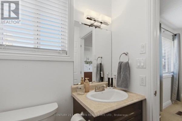 Bathroom with vanity, sink, toilet, and mirror - 28 Hickory Grove Belleville