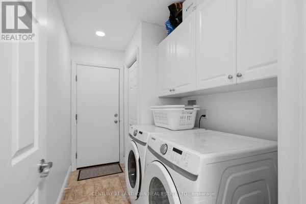 Stacked white washer and dryer with white cabinets - 28 Hickory Grove Belleville