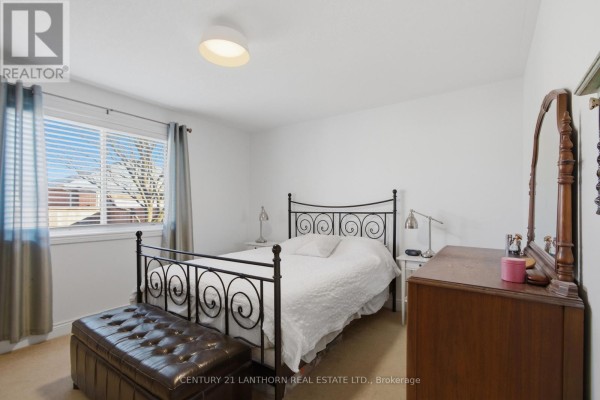 Bedroom with metal bed, ottoman, and dresser - 28 Hickory Grove Belleville