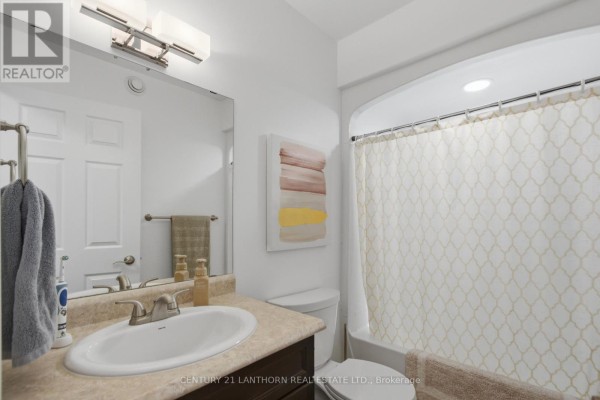Bathroom with vanity, sink, tub, and shower curtain - 28 Hickory Grove Belleville