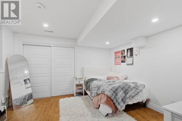 Bedroom with arched mirror and sliding closet doors - 28 Hickory Grove Belleville