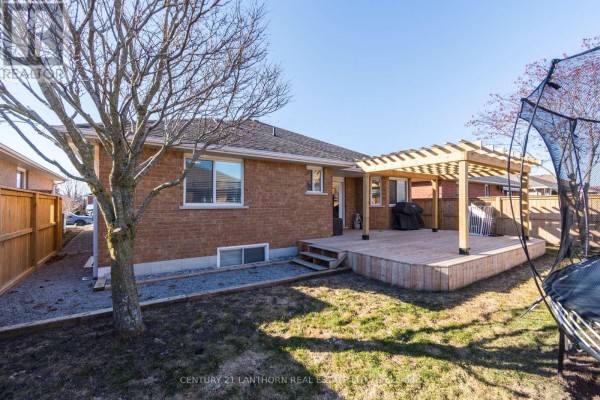 Deck with pergola and grill, trampoline in yard - 28 Hickory Grove Belleville