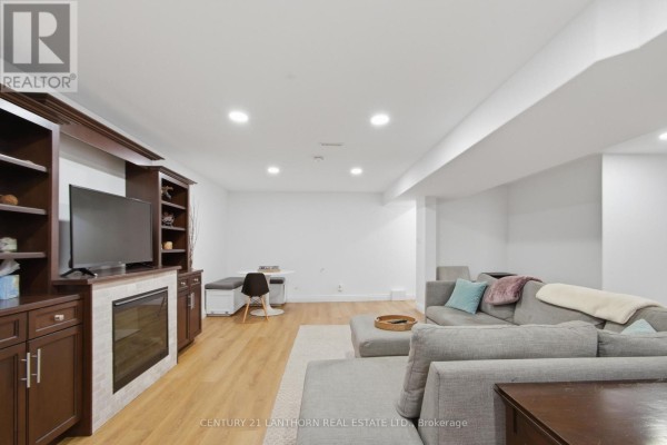 Living room with fireplace, entertainment center, and sectional sofa - 28 Hickory Grove Belleville
