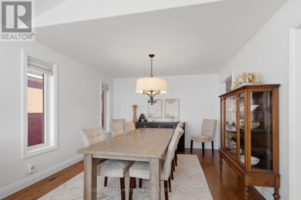 Dining room with wood table, upholstered chairs, and china cabinet - 28 Hickory Grove Belleville