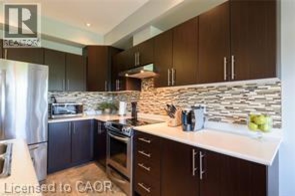 Kitchen with dark wood cabinets, stainless steel appliances, and tiled backsplash. - 28 Madonna Drive, Hamilton