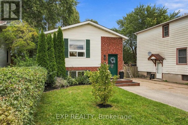 A residential home's facade with a manicured front lawn and mature trees. - 28 Maitland Street, Thorold