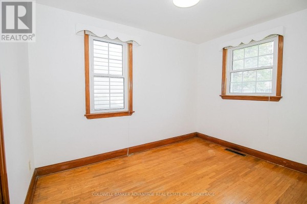 Bedroom with hardwood floors and two windows - 28 Marshall Avenue Welland