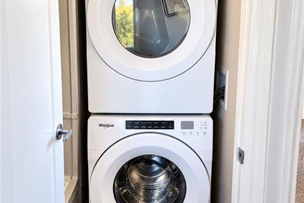 Stacked white Whirlpool washer and dryer inside a closet. - 28 Nieson Street, Cambridge