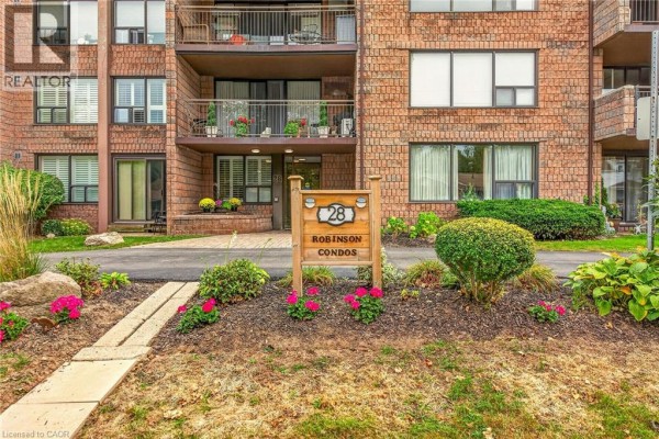 Close-up of the entrance to Robinson Condos at 28 Robinson Street N with landscaping. - 28 Robinson Street N Unit# 103, Grimsby