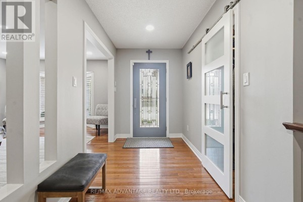 Bathroom featuring a vanity, mirror, and shower with neutral tones. - 28 Wynfield Lane, Middlesex Centre