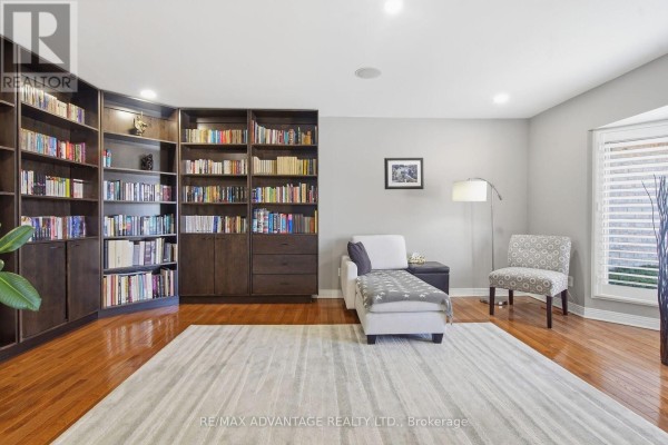 Sunroom with large windows, built-in seating, and storage drawers. - 28 Wynfield Lane, Middlesex Centre