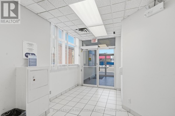 Interior hallway with tiled floor, white walls, and glass double doors. - 280 Main Street E, Hawkesbury