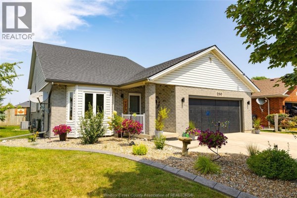 Front exterior of brick and vinyl home with garage door and covered porch in daylight. - 280 Mclellan, Amherstburg