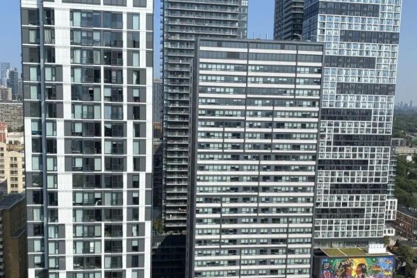 View from a high floor of multiple apartment buildings with glass and white facades. - 2805 - 47 Mutual Street, Toronto