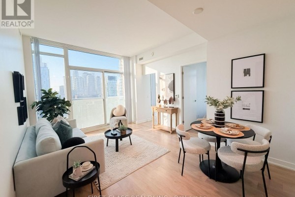 Indoor lounge area with a fireplace, tiered seating, patterned decorative screens, and wood-paneled walls. - 2805 - 501 Yonge Street, Toronto