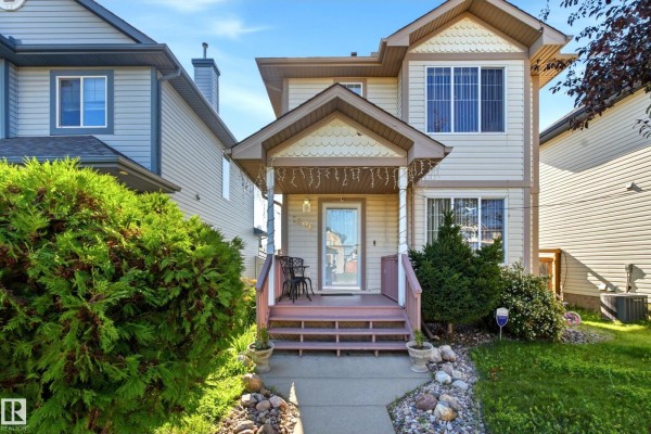 Exterior of a beige house with a covered porch and brown railings. - 2806 31 St Nw Nw, Edmonton