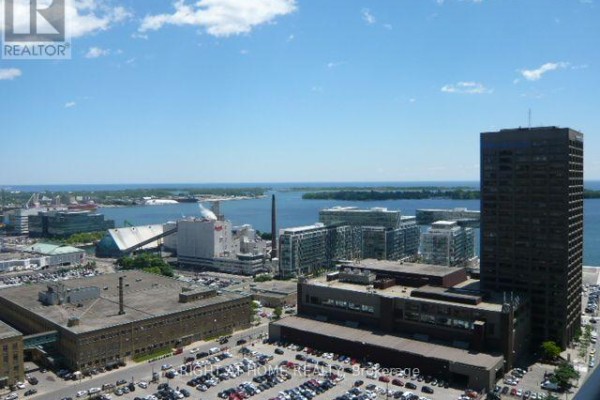 View of Toronto harbourfront with buildings and water from a high-rise apartment. - 2807 - 18 Yonge Street, Toronto