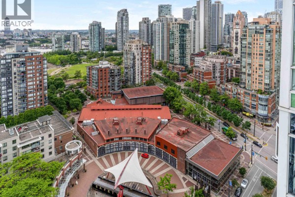 Aerial view of a city neighborhood with market buildings, parks, and tall residential towers. - 2807 1199 Marinaside Crescent, Vancouver