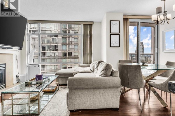 Living room with a large sectional sofa, glass coffee table, and floor-to-ceiling windows. - 2807 1199 Marinaside Crescent, Vancouver