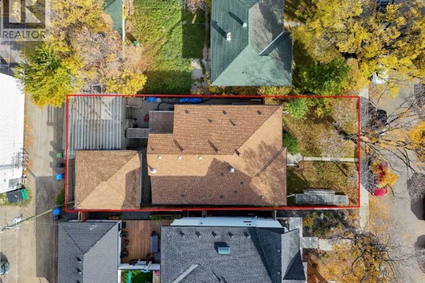 Aerial view of the property's roofline and backyard with a detached garage. - 2807 32 Street Sw, Calgary