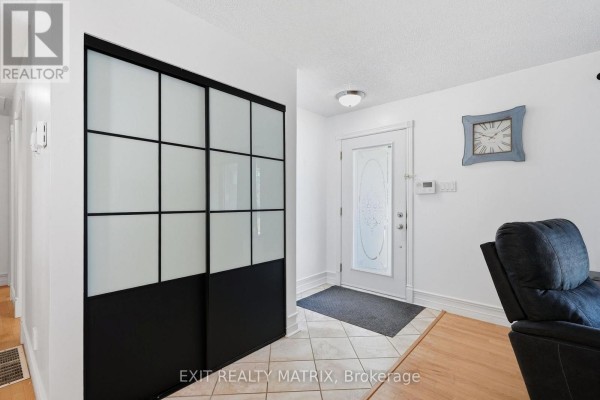 Living room showing leather sofas, entertainment center, and view of dining area. - 2807 Leonard Street, Clarence Rockland