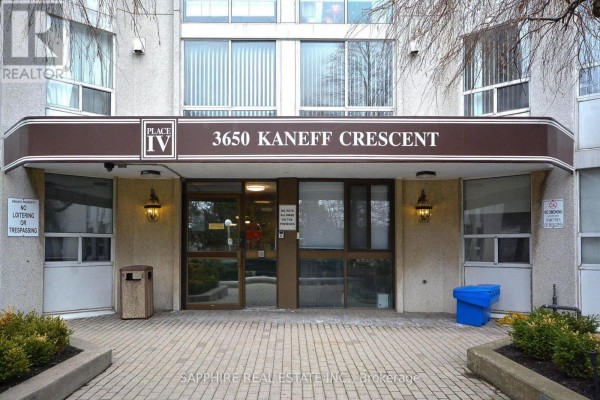 Front entrance of Place IV at 3650 Kaneff Crescent with beige facade and glass doors. - 2808 - 3650 Kaneff Crescent, Mississauga