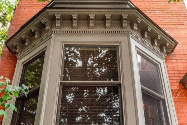 Detailed view of the decorative molding around the bay window's exterior. - 282 Hess Street S, Hamilton