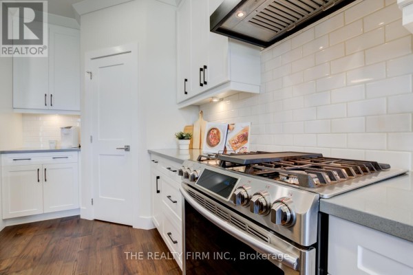 White subway tile backsplash in a kitchen with stainless steel appliances and dark hardware. - 283 Elizabeth Street, Southwest Middlesex
