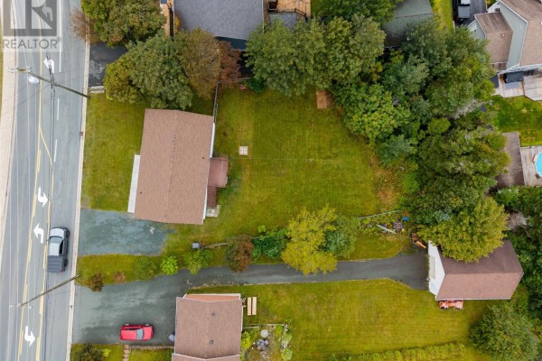 Aerial view of 283 Fowlers Road property showing the house, driveway, backyard, and surrounding trees. - 283 Fowlers Road, Conception Bay South