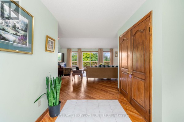 Interior entryway with light green walls, hardwood floors, and double wooden doors. - 2840 2nd Concession Road, Elizabethtown Kitley