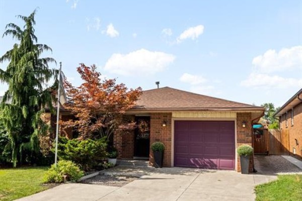 Kitchen with grey cabinets, a double sink, stainless steel refrigerator, and window blinds. - 2841 Garvey Crescent, Windsor