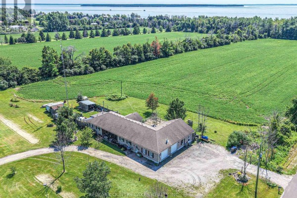 Overhead view of the property showing the bungalow, driveway, garage, and surrounding fields within a white boundary. - 2865 Concession A Road, Ramara
